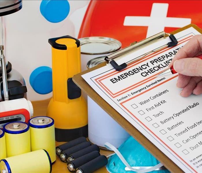Clip board with an emergency preparedness checklist, batteries, flashlightts